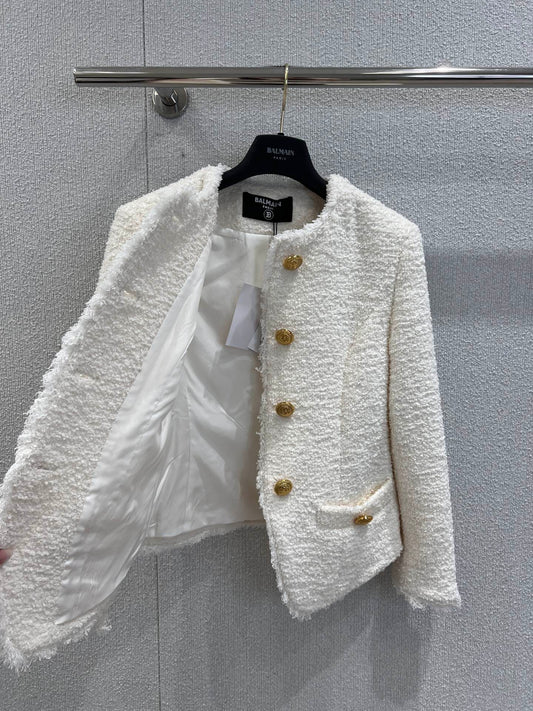 Gold-buttoned, slim-fit cropped tweed jacket.